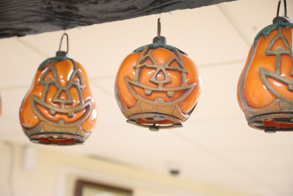 A collection of eight vintage glass and painted metal Halloween pumpkin lanterns, various